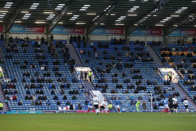 Fans watch Pompey's home game with Peterborough on December 5, 2020 - one of only two occasions supporters have been inside the ground to watch a game since last March. Picture: PinPep Media / Joe Pepler
