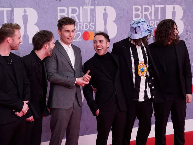 British singer and songwriter Sam Fender (third left) poses on the red carpet upon his arrival for the BRIT Awards 2022.