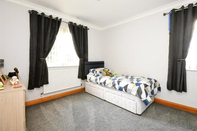 The third bedroom is quaint and ideal for one of the kids. A window overlooks the garden.