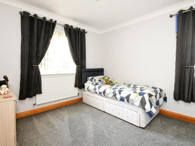 The third bedroom is quaint and ideal for one of the kids. A window overlooks the garden.
