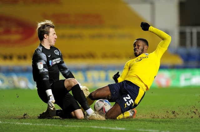 Craig MacGillivray thwarts Olamide Shodipo, one of three late saves which ensured Pompey claimed a 1-0 victory at Oxford United on Tuesday. Picture: Alex Burstow/Getty Images
