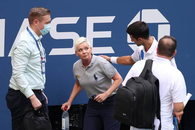 Novak Djokovic tends to lineswoman Laura Clark after inadvertently striking her with a ball during his Men's Singles fourth round match in the US Open - he was disqualified as a result. Photo by Al Bello/Getty Images.