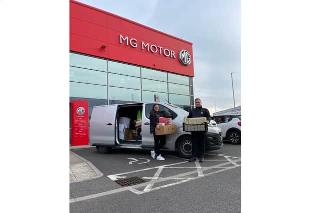 Taylor Rogers (from Richmond Hyundai) with volunteer Katy Tracey loading up the van to donate the gifts