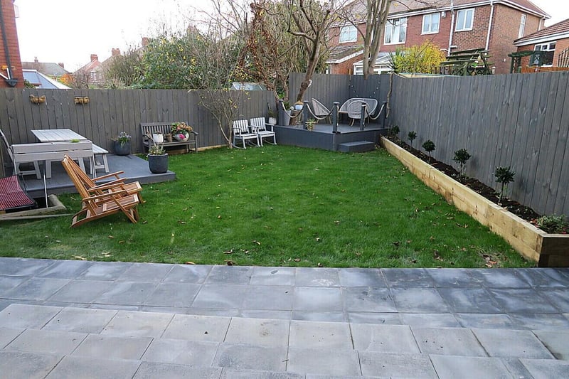 The rear garden offers plenty of sitting areas and a raised decking feature.