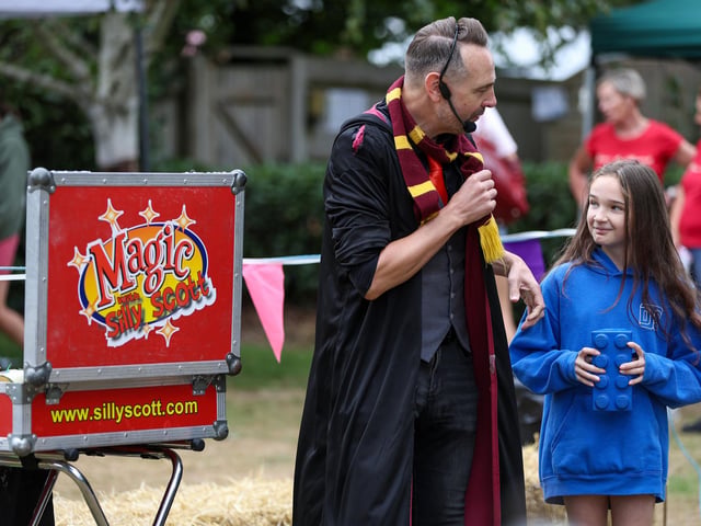 Peggy Hodges, 11, helps out Silly Scott. Picture: Chris Moorhouse (160825-26)