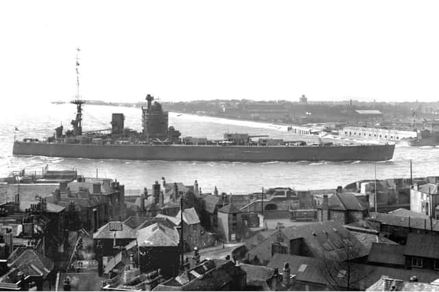 HMS Nelson entering Portsmouth Harbour before 1936. The tram, well camouflaged down in Old Portsmouth, gives us the date clue. That was the year the last tram ran in the city. The tram also gives you some idea of the scale of Nelson.