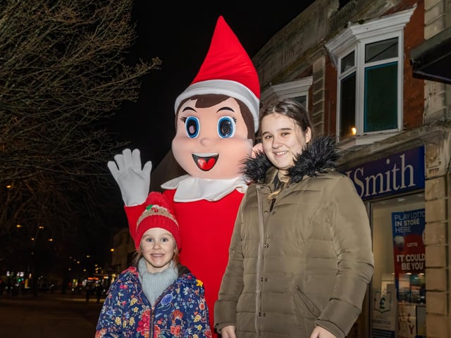 Phoenyx, 4, and Raynne, 15, with The Elf at the Waterlooville Christmas light switch on. Photos by Alex Shute