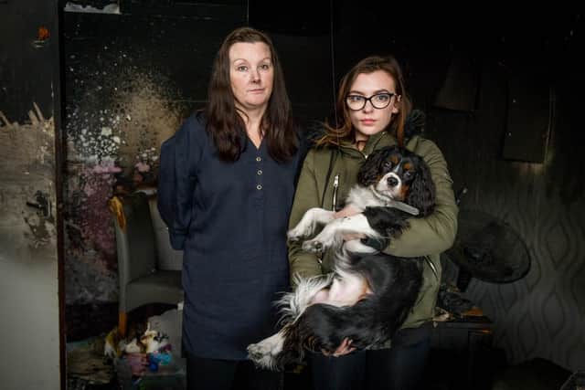 Victoria King and her daughter Ellie Rushforth with their dog, Buddy in the living room where the fire was.
Picture: Habibur Rahman
