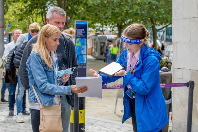Emma Lapping and Chris Bevan having their ticket scanned as they enter the Historic Dockyard. Picture: Habibur Rahman