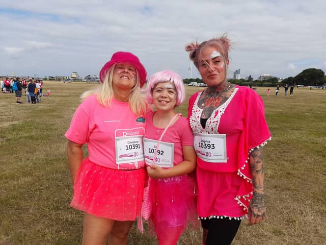 From left, Christine Whittingham, 61, Tilly Phillips, 12 and Sophia Whittingham, 34, at the Race for Life in Southsea. Picture: David George