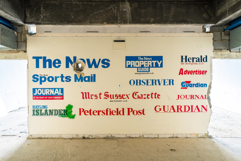 An internal wall reveals the newspaper titles once produced and printed at The News Centre