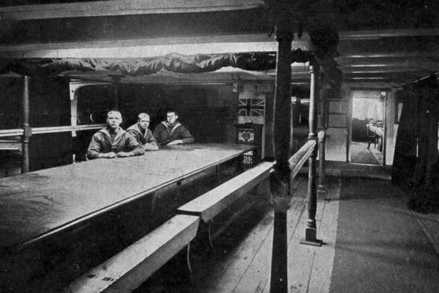Nelson's cabin on HMS Victory circa 1910.Taken in Horatio Nelson's cabin on board HMS Victory. At this time of course the Victory was still moored  in Portsmouth Harbour, where tourists used to pay a ferryman to get out to her. As the sailors are wearing sea jerseys under their jackets, it must be wintertime.