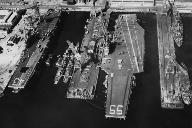 Aerial view of the Forrestal-class aircraft carrier the USS Forrestal (CV-59) of the United States Navy tied up alongside the smaller Midway-class aircraft carrier the USS Coral Sea (CV-43) at the Portsmouth Naval Shipyard on 25 October 1955 at Portsmouth, New Hampshire, United States.  (Photo by Keystone/Getty Images)