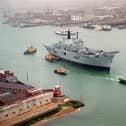 HMS Ark Royal being towed by tugs through the narrows, as she leaves Portsmouth Naval Base for Rosyth in 1999. Picture: Mike Scaddan 992149-2