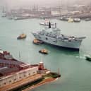 HMS Ark Royal being towed by tugs through the narrows, as she leaves Portsmouth Naval Base for Rosyth in 1999. Picture: Mike Scaddan 992149-2
