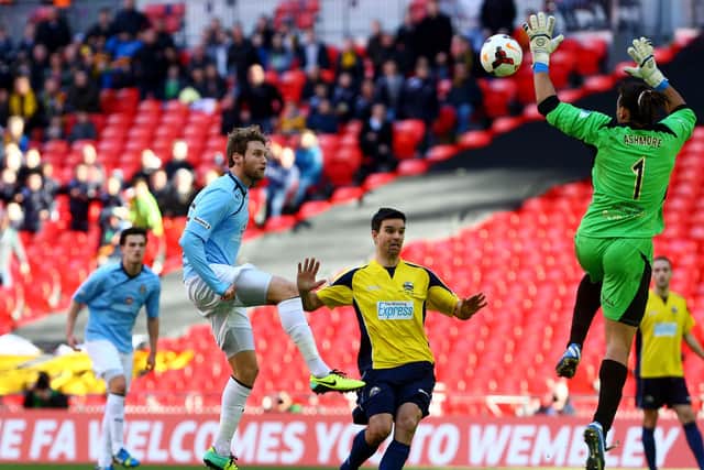 Ryan Bird was on loan to Cambridge United from Pompey when they won the FA Trophy at Wembley in March 2014. Here he is chipping Gosport keeper Nathan Ashmore for the opener. Picture: Gareth Fuller