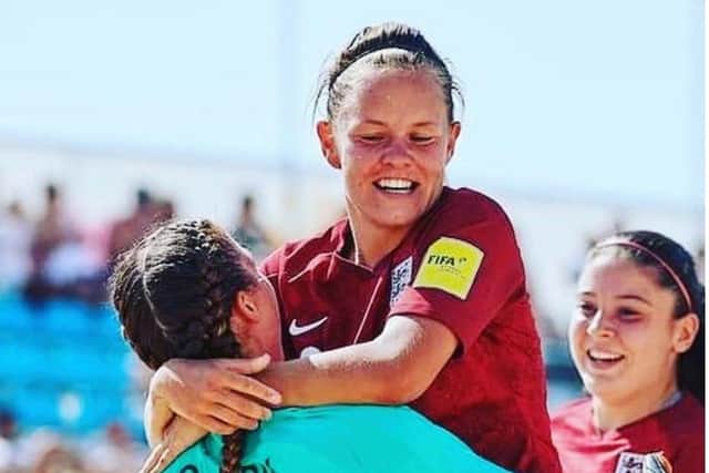 Katie James celebrates an England Beach Soccer victory.
