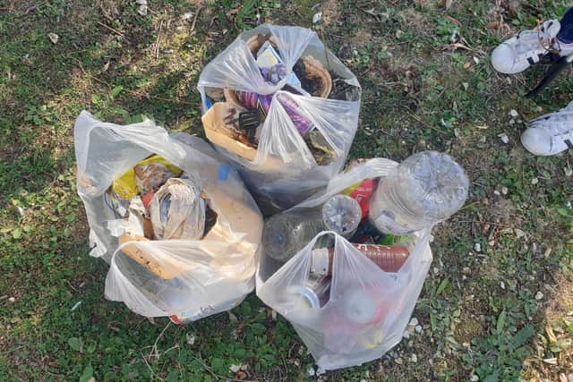 Abigail Buckland, 11 from North End, cleaned up Baffins Pond and hopes to inspire others to do the same. Pictured: Three bags of litter collected by Abigail