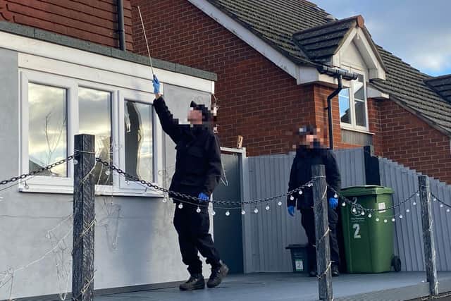 Two crime scene investigators hunt search a guttering after the bloody brawl in Dormington Road, Paulsgrove on Wednesday.