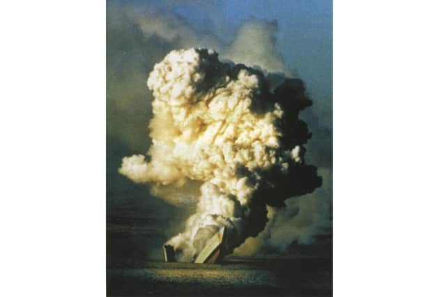 HMS Antelope sinks under the waves with a fire raging inside her melting superstructure