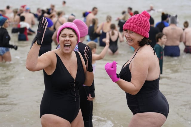 People take part in the Gosport New Year's Day Dip in The Solent at Stokes Bay, Gosport, Hampshire, to raise money for Gosport and Fareham Inshore Rescue Service.