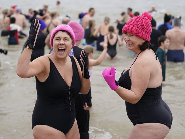 People take part in the Gosport New Year's Day Dip in The Solent at Stokes Bay, Gosport, Hampshire, to raise money for Gosport and Fareham Inshore Rescue Service.