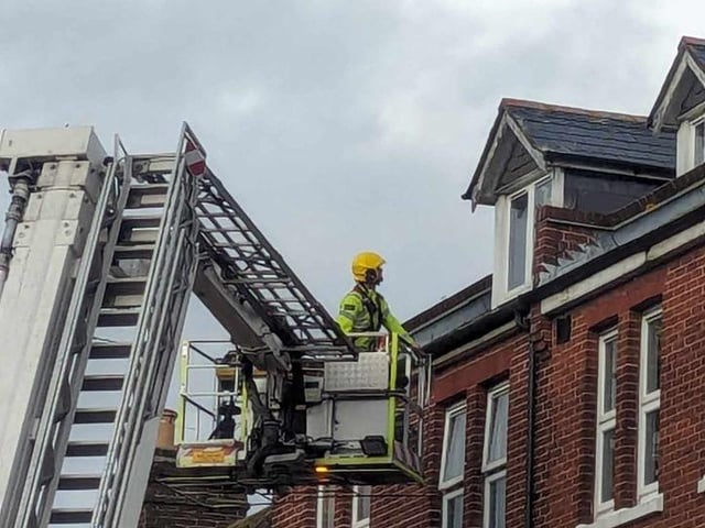 Firefighters fixing loose roof tiles and a sign above Poppins Cafe in North Street, Havant, on January 2.