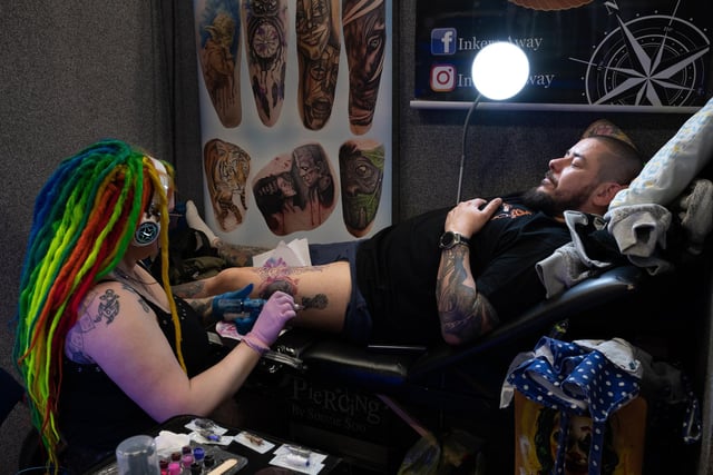 Pictured is: Susie Sue works on a tattoo for Liam Simpson
Picture: Keith Woodland (010421-54)