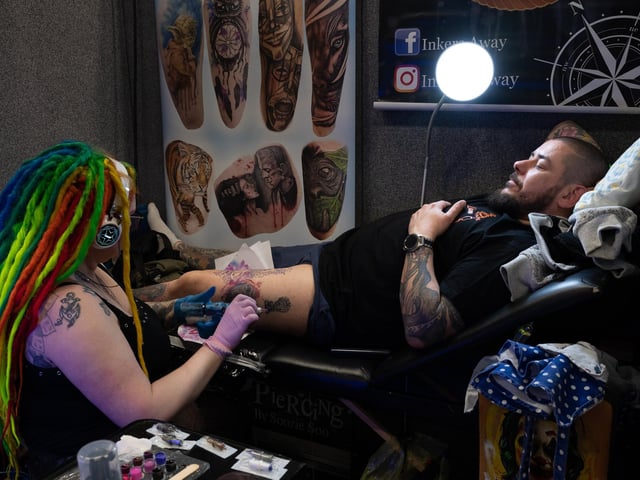 Pictured is: Susie Sue works on a tattoo for Liam Simpson
Picture: Keith Woodland (010421-54)