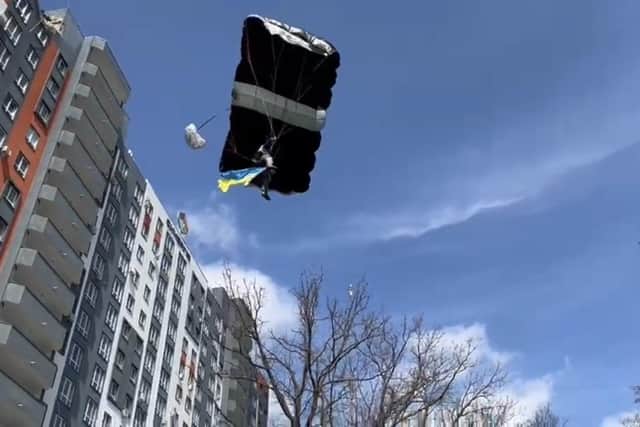 Ex Waterlooville paratrooper John 'The Flying Fish" Bream pictured base-jumping with a Ukrainian flag from the top of a bombed-out apartment block in the Ukrainian city of Bucha.