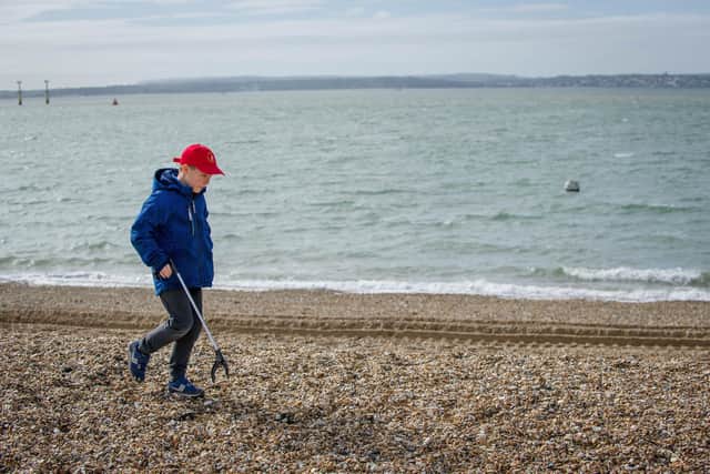 Chernobyl children are litter picking on Southsea beach opposite Clarence Pier on 17 March 2020.
Pictured: Danyo 10 looking for litter.
Picture: Habibur Rahman