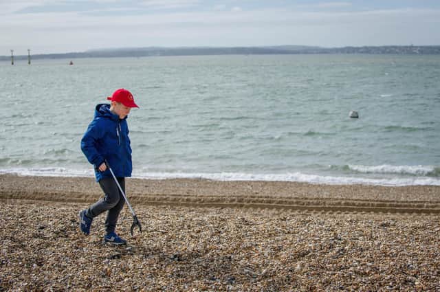 Chernobyl children are litter picking on Southsea beach opposite Clarence Pier on 17 March 2020.

Pictured: Danyo 10 looking for litter.

Picture: Habibur Rahman