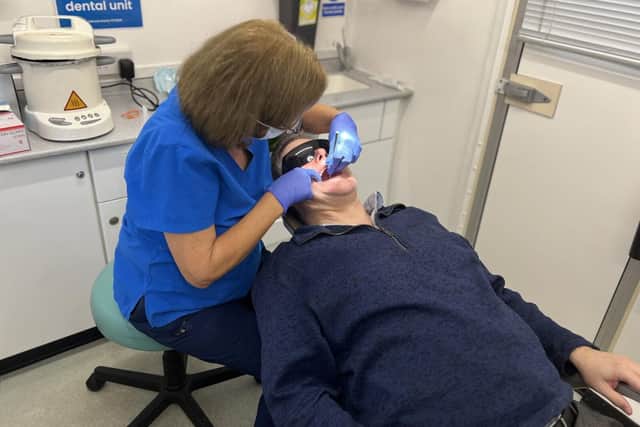 Dentist Mary Green treats a patient in the mobile clinic.