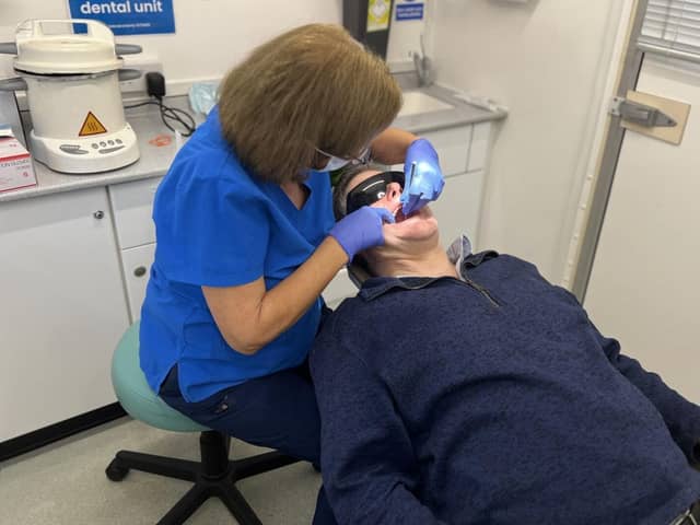 Dentist Mary Green treats a patient in the mobile clinic.