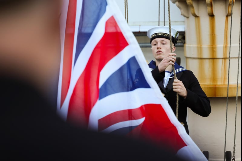 Pictured: Morning colours being conducted before the Trafalgar Day ceremony on HMS Victory.