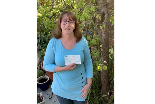 Sue Hindmarch who set up the Just Giving page with the cheque for Richard Small. Picture Sue Hindmarch