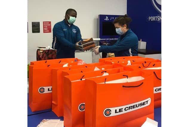 Pompey in the Community has been boosted by a donation of £100k from Barclays. Pictured: Volunteers packing food parcels