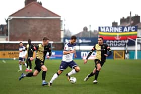 Josh Taylor pictured with Marine duo James Joyce and Josh Hmami during the FA Cup second round tie at the end of November. Hawks lost to a late goal and Marine are now looking forward to welcoming Tottenham. Photo by Jan Kruger/Getty Images.