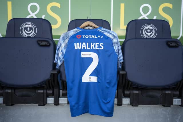 An Anton Walkes Pompey shirt with his name and old number is draped across a seat in the Fratton Park dugout for today's League One game against Exeter.