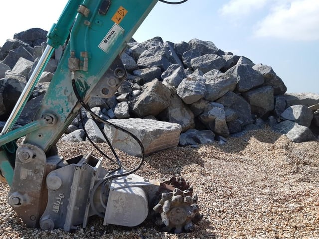 The 'rock muncher' has arrived and is cutting larger rocks into smaller ones to help create tide pools
