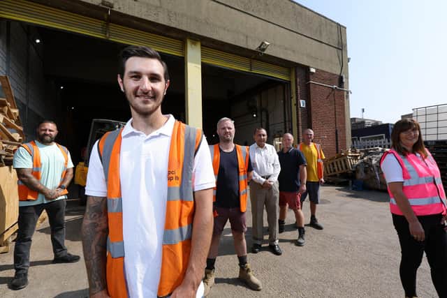 Connor Hoare, front, with the team, left to right, Colin Eames, Johnny Hoare, Basir Sami, Darren Hoare, Tony Parrack and Michele Hoare. TIPCI Group Ltd in Claybank Rd, who recycle pallets thereby preventing them going to landfillPicture: Chris Moorhouse (jpns 220721-05)