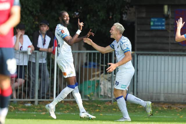 Mo Faal and Danny Wright celebrate after the former had netted Hawks' third goal at Hampton & Richmond. Picture by Dave Haines