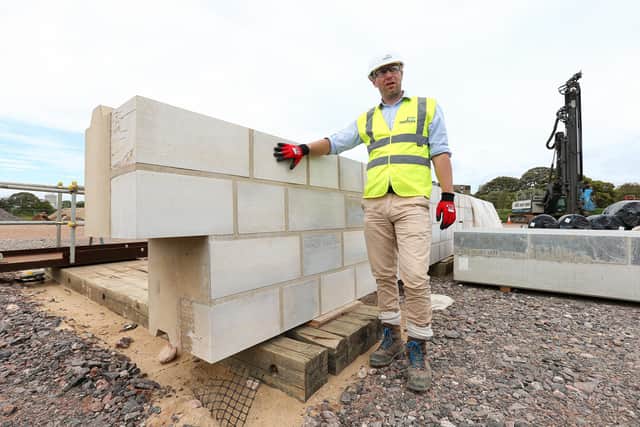 Project manager Rupert Teasdale with one of the specially engineered concrete and stone blocks that will clad the steel piles and face the sea. Construction work on sea defences at Long Curtain and Spur Redoubt, Portsmouth
Picture: Chris Moorhouse (jpns 110621-44)