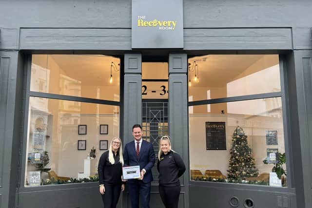 Stephen Morgan presents The Recovery Room with an award as the area's friendliest business after a resident poll.
