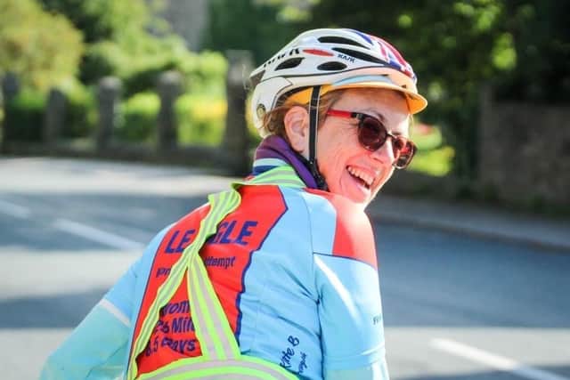 Marcia Roberts has become the first woman to complete the cycle from Land's End to John o'Groats and back again. Pictured: Marcia keeping in high spirits on her journey