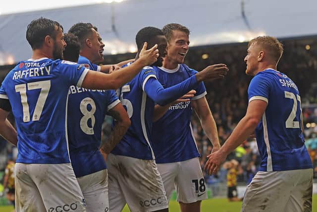 Pompey's players congratulate Jack Sparkes after his corner laid on the winner for Conor Shaughnessy against Carlisle. Picture: Barry Zee