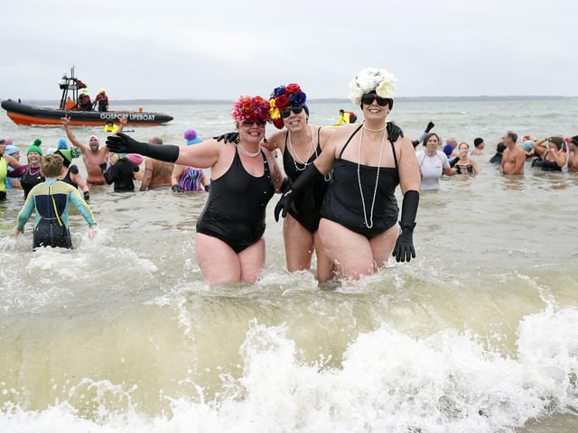 People take part in the Gosport New Year's Day Dip in The Solent at Stokes Bay, Gosport, Hampshire, to raise money for Gosport and Fareham Inshore Rescue Service.