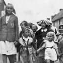 Little Linda Griffin, in the white dress, leading the way for the party in South Street, Emsworth, on VE Day.