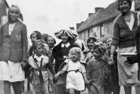 Little Linda Griffin, in the white dress, leading the way for the party in South Street, Emsworth, on VE Day.