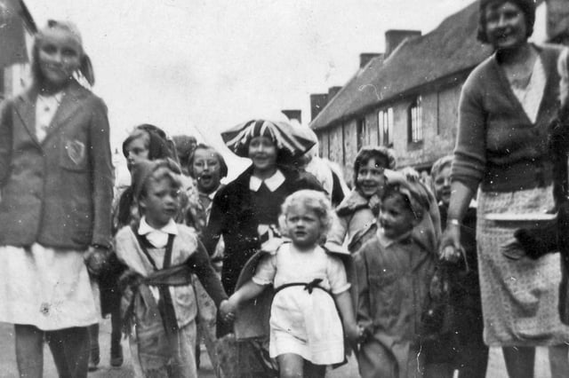 Little Linda Griffin, in the white dress, leading the way for the party in South Street, Emsworth, on VE Day.